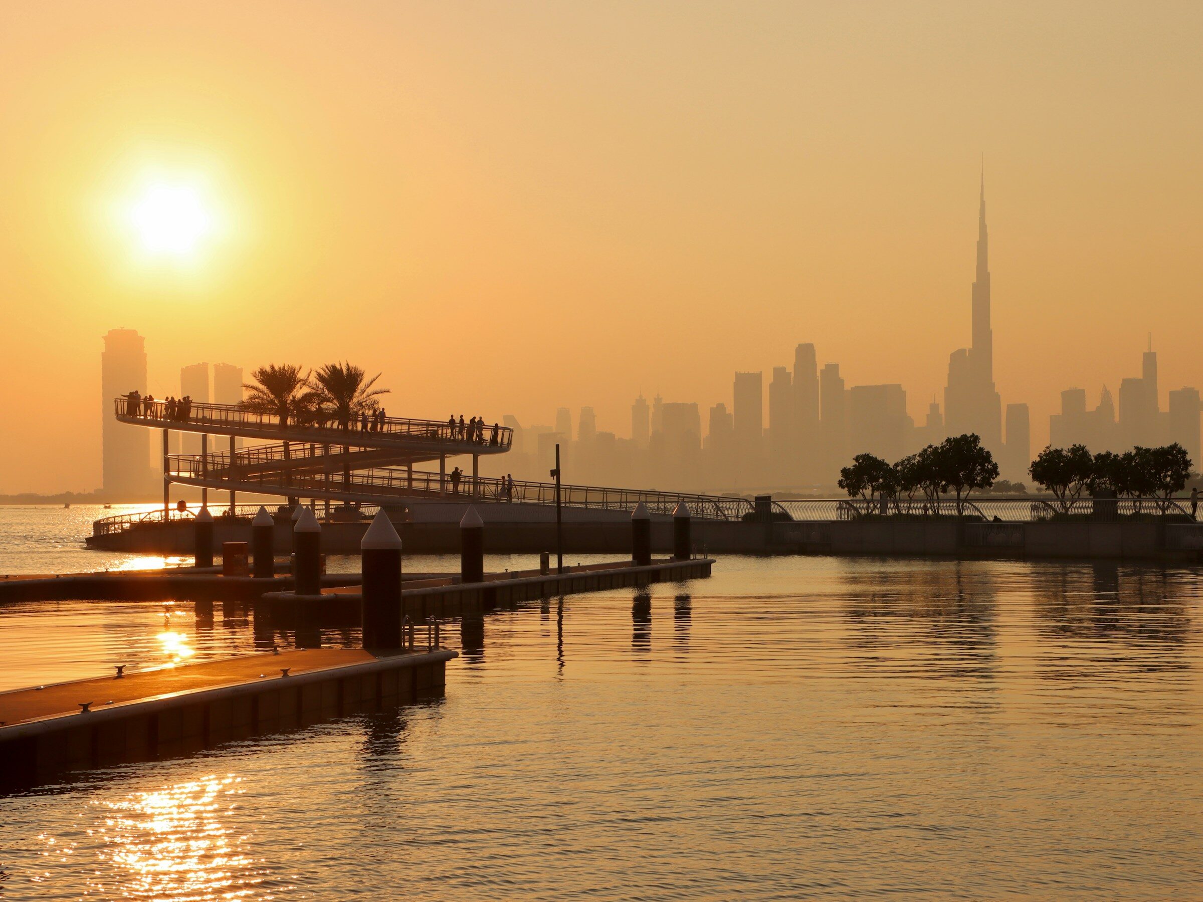 The sun setting over the Dubai skyline from the Creek
