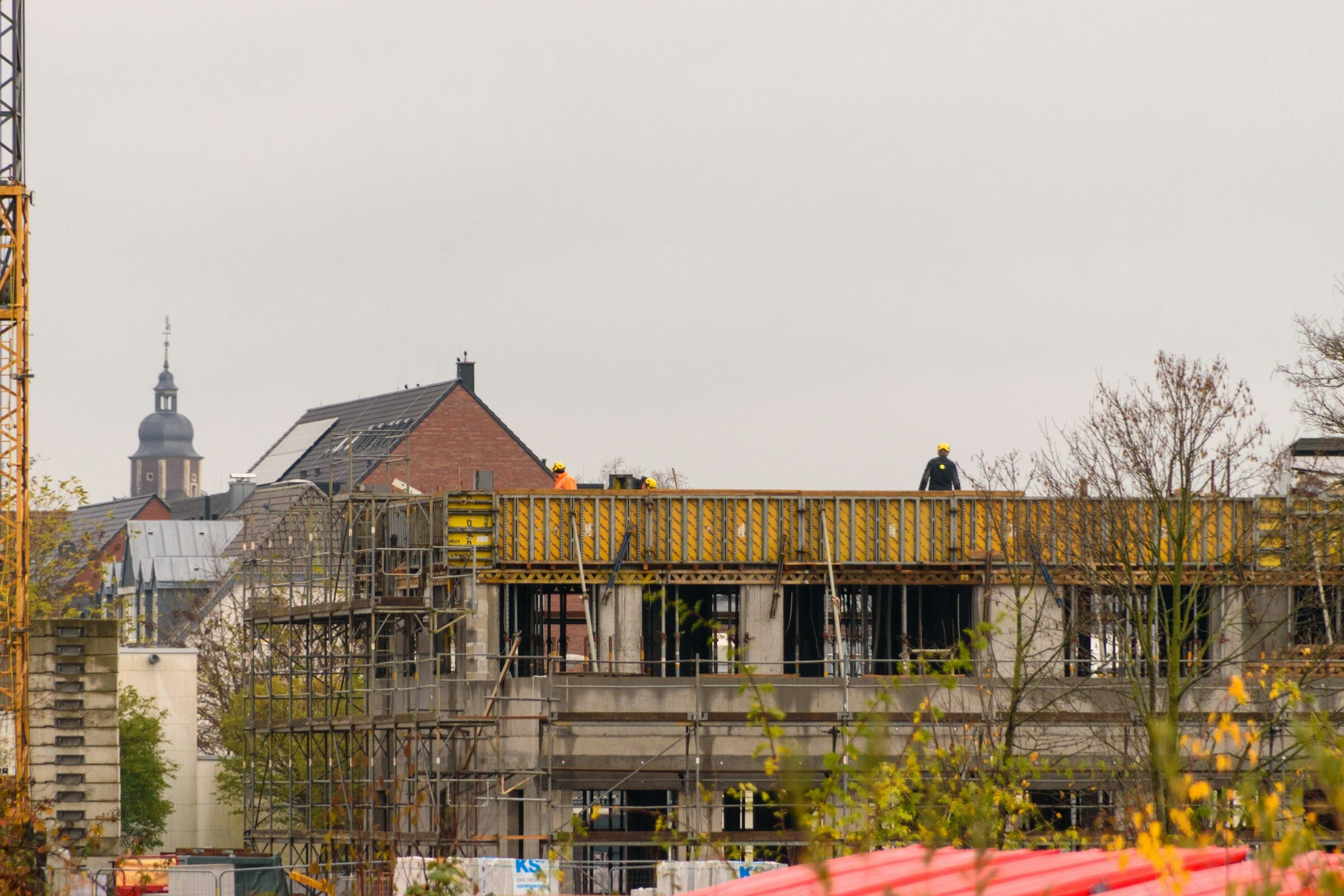 A construction site with workers and a crane