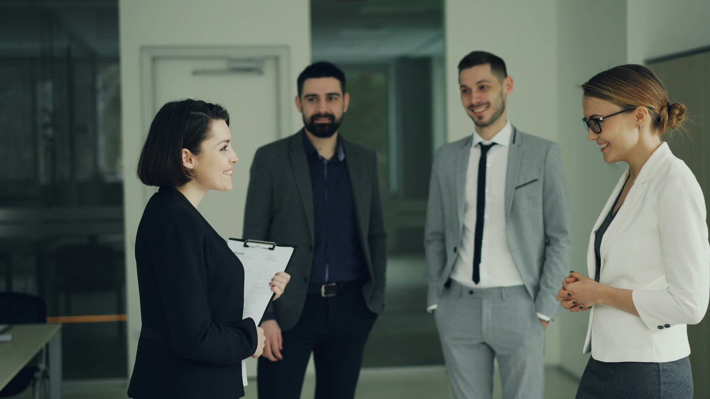 Four colleagues discussing a decision in an office