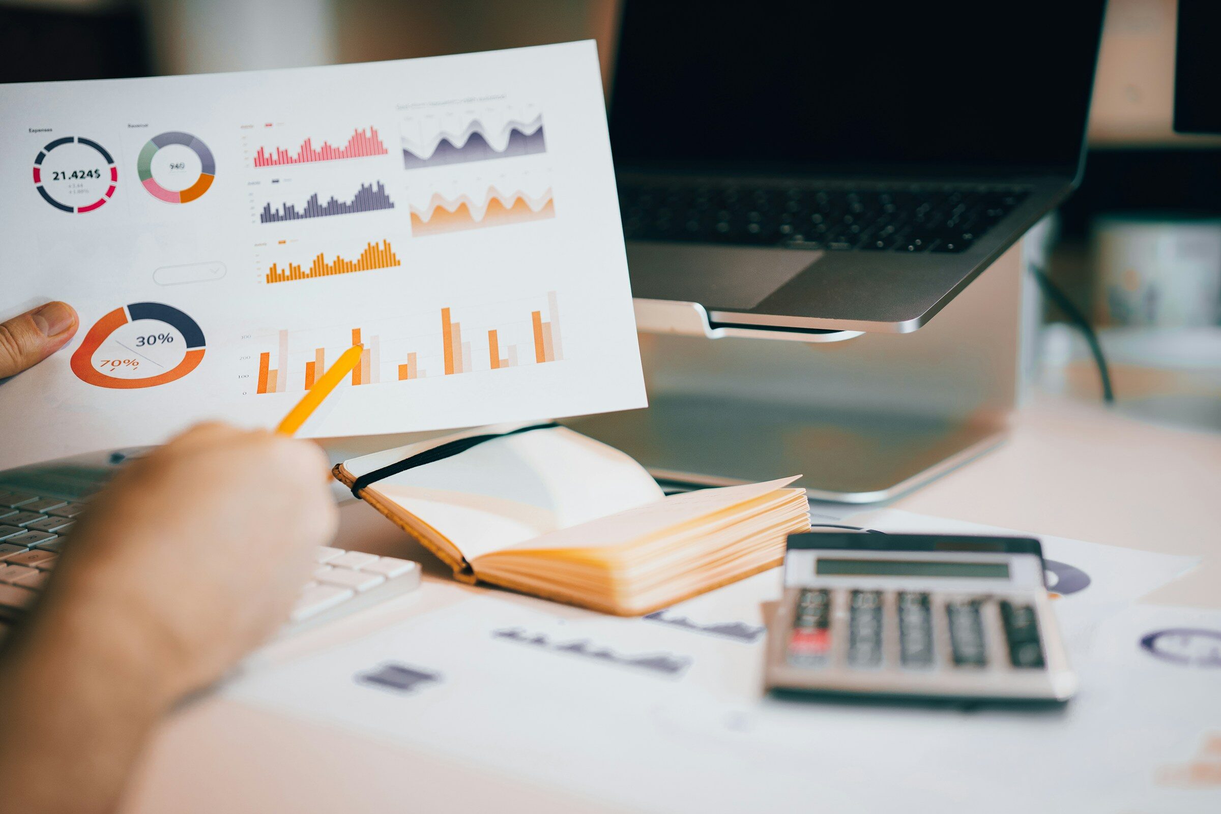 Holding a printout up against the figures on a laptop