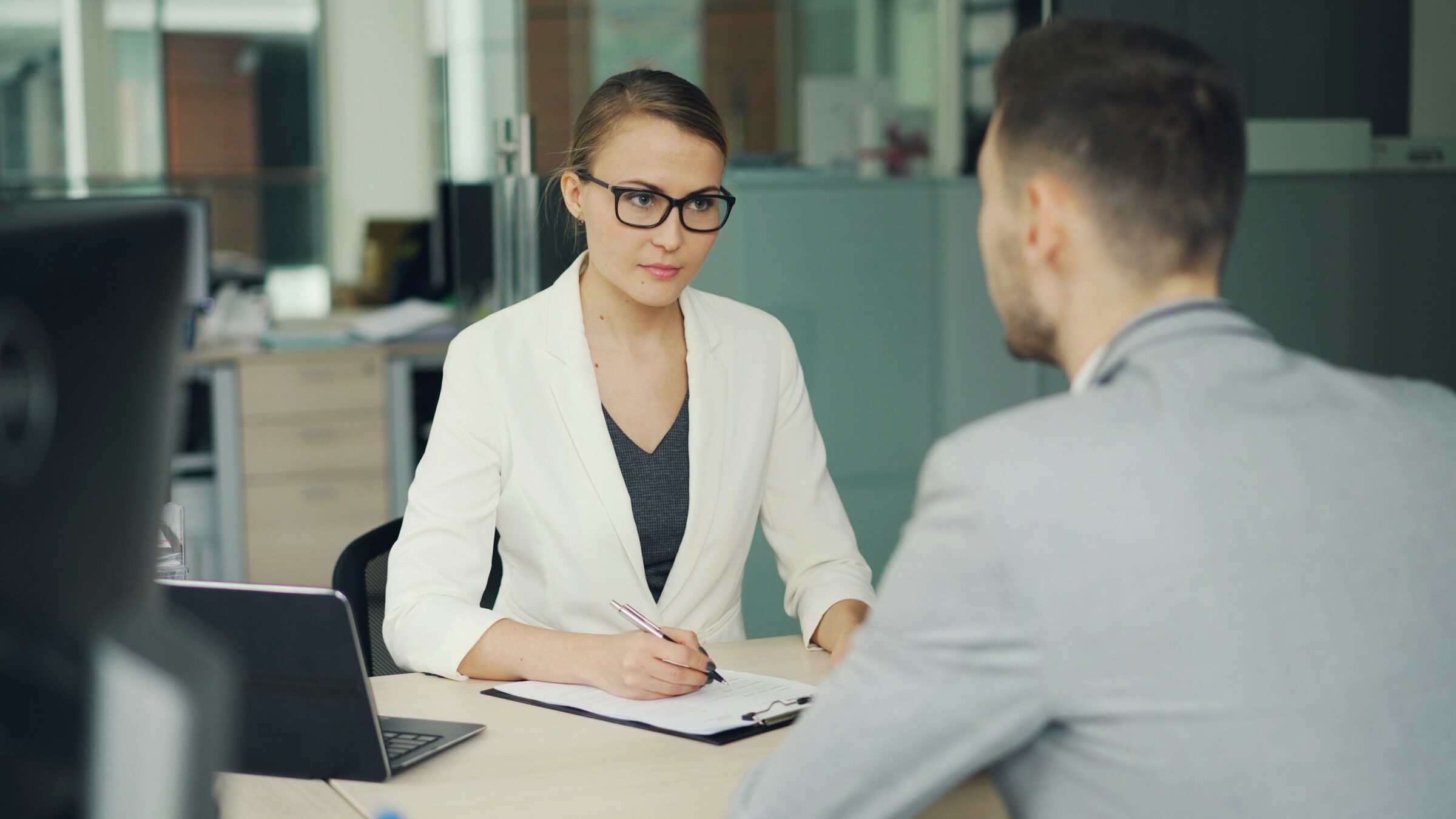 A new starter being interviewed across an office desk