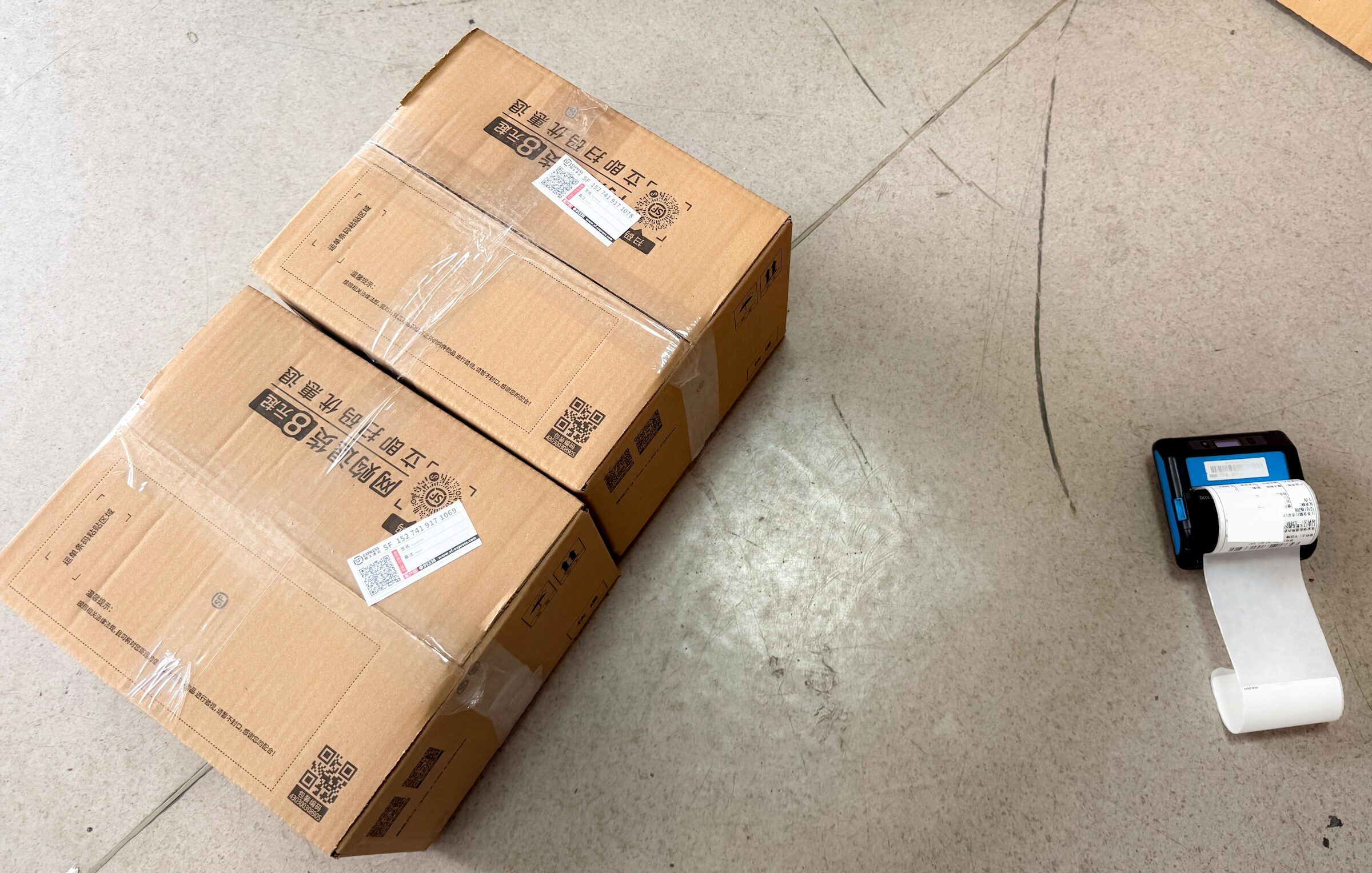 Shipping boxes beside a label printer