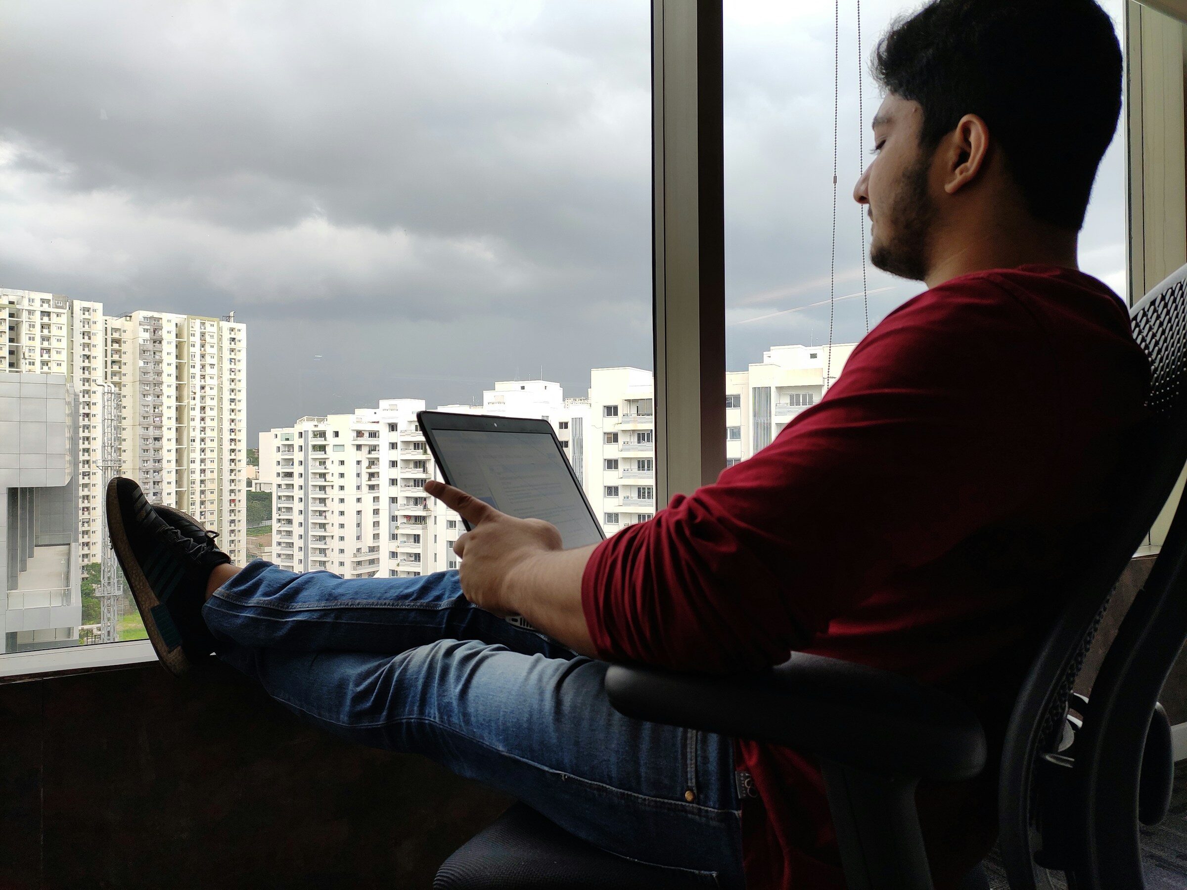 Working through figures by a window in a quiet office