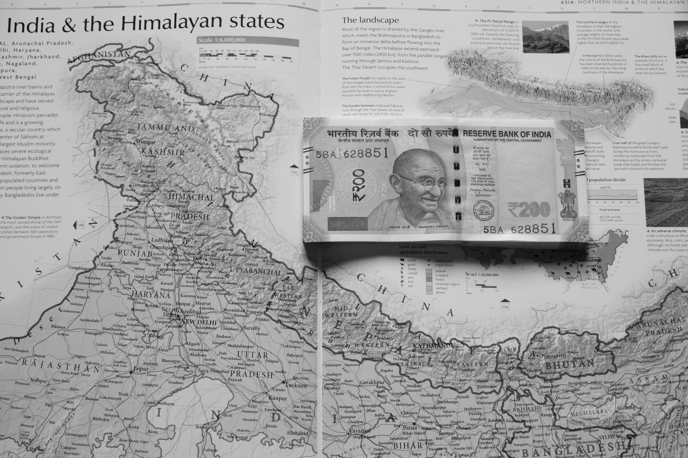 Indian currency resting on a map of India