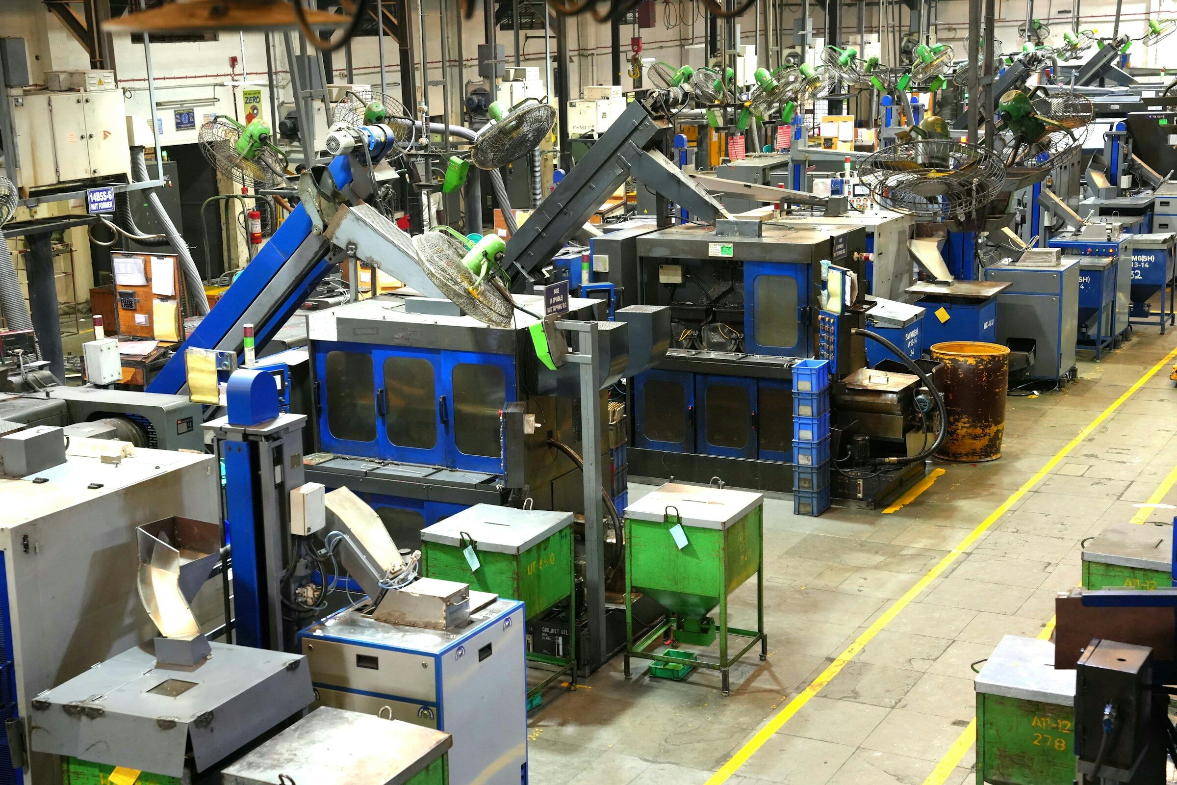 A factory floor with machinery and yellow safety lines