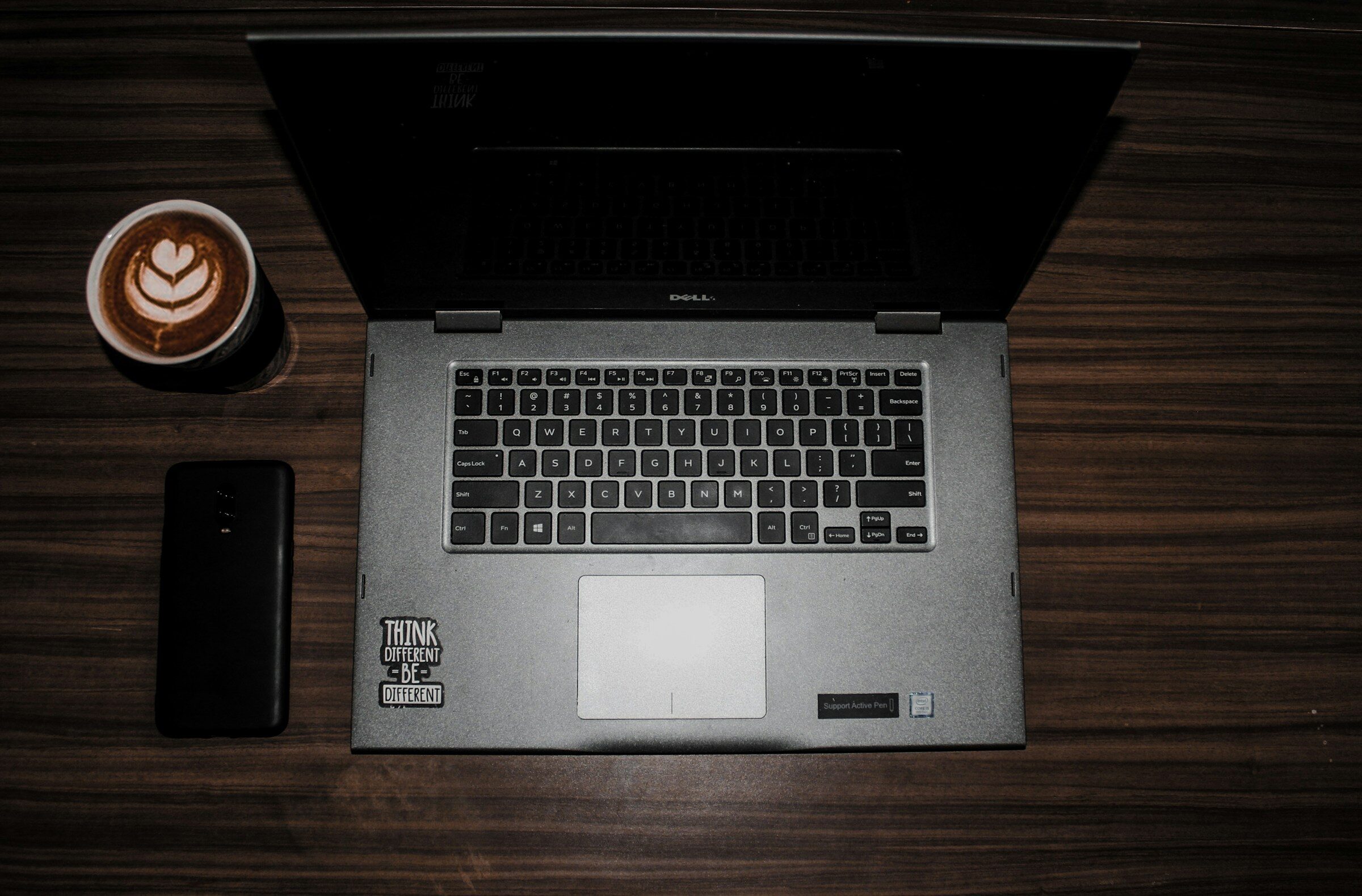 A laptop on a wooden table