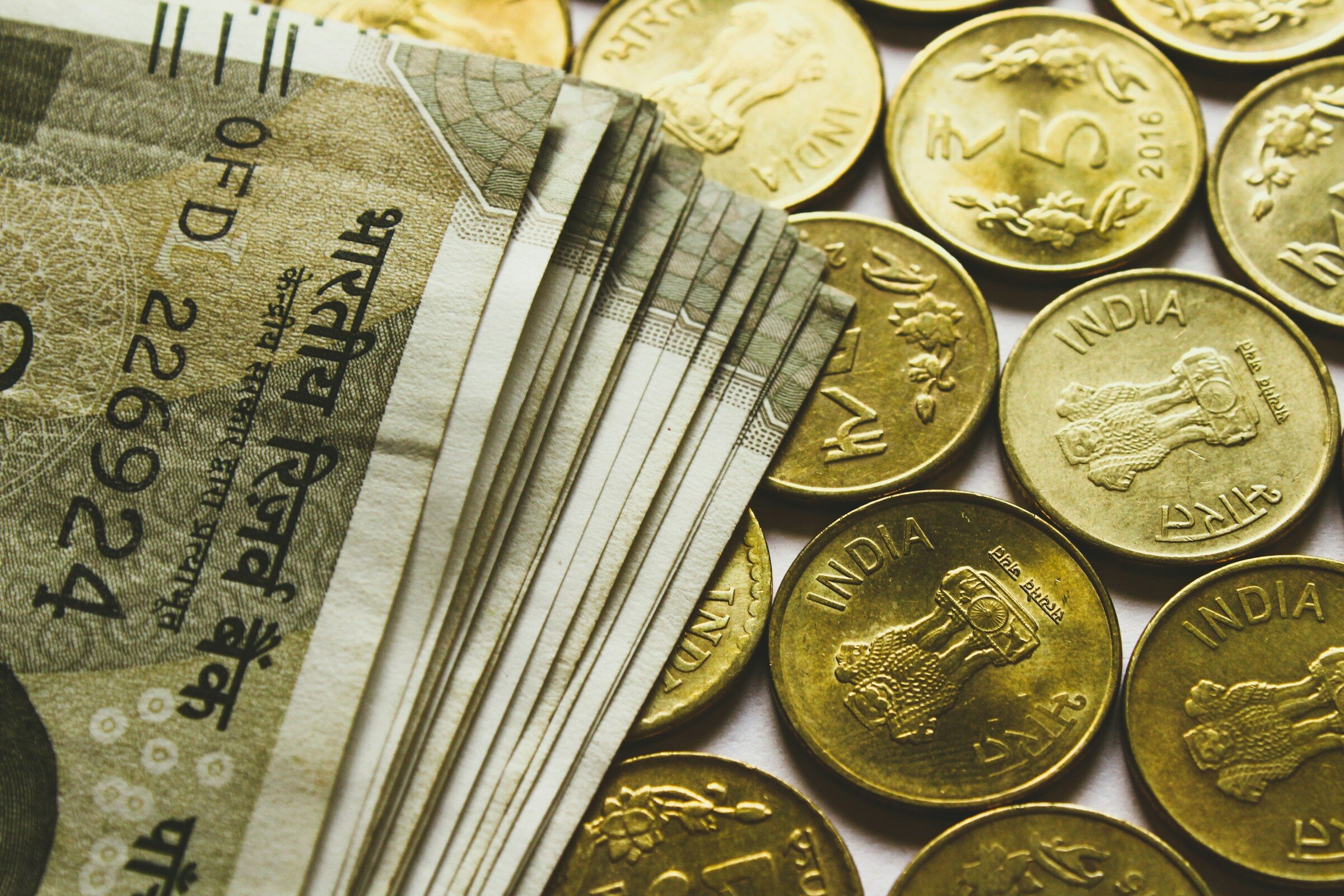 Rupee coins and banknotes on a table
