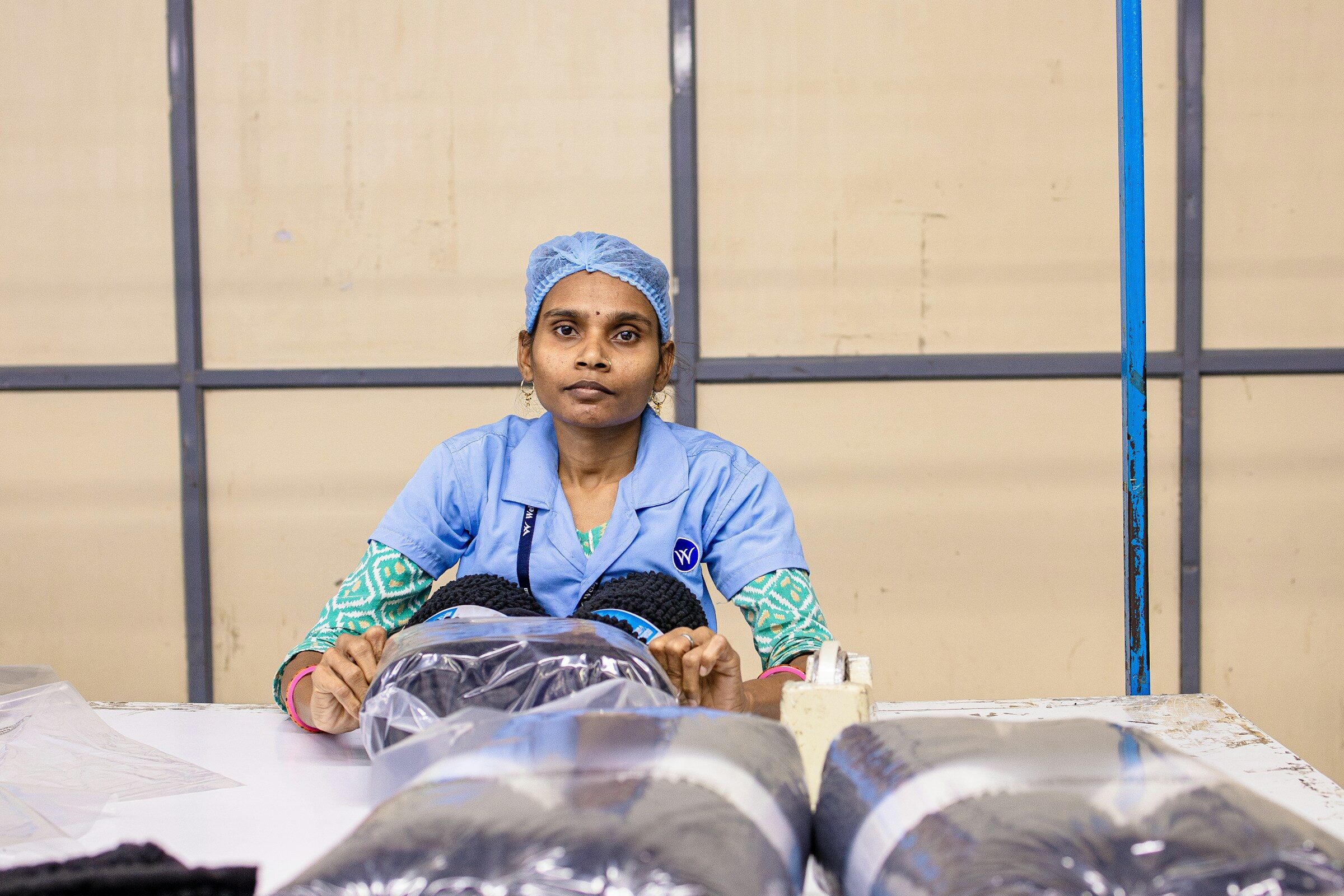 A woman handling packaged products in a warehouse
