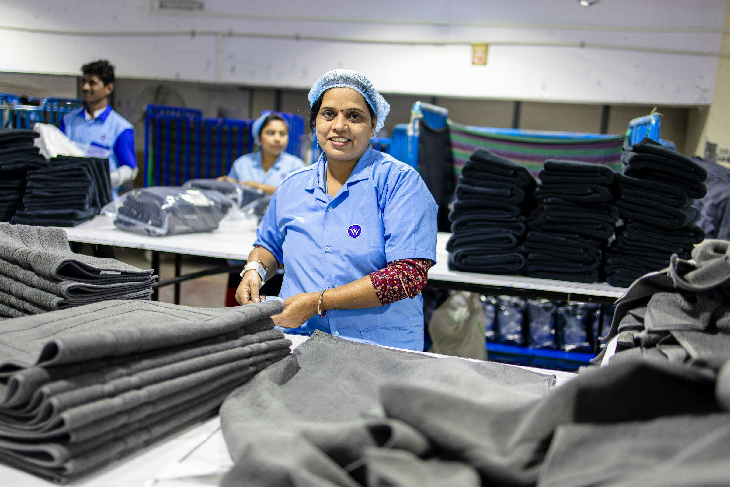 Factory workers organising finished clothes