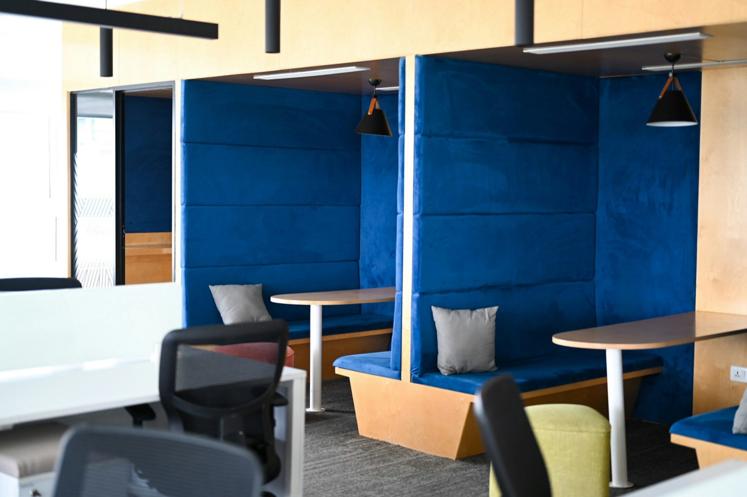A contemporary workspace with blue seating