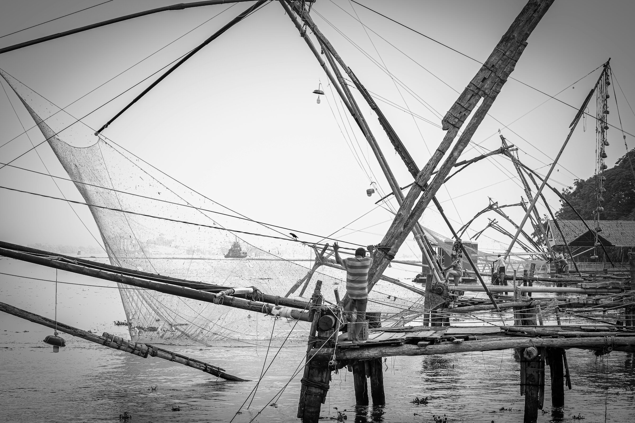 Traditional Chinese fishing nets at Fort Kochi with workers