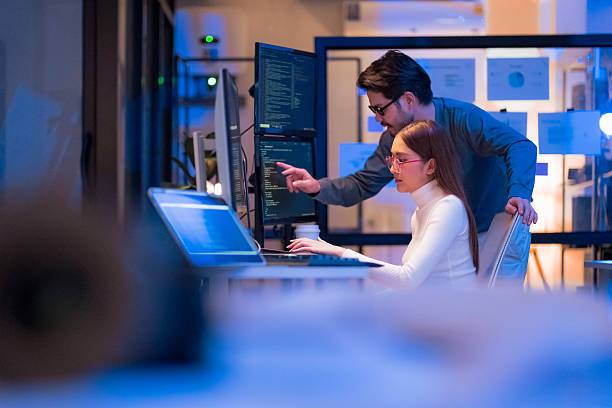 Senior developer reviewing back-end code with a colleague
