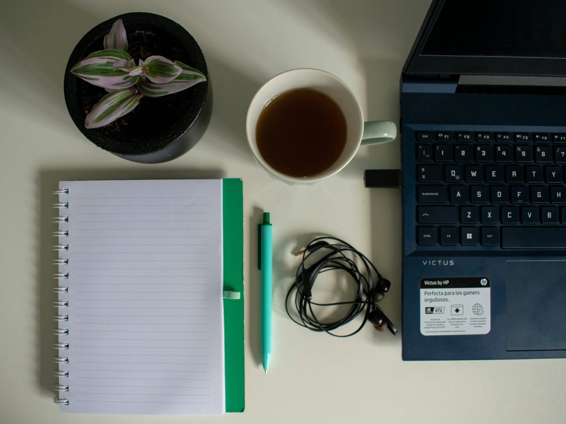 A laptop and notebook on a small-business desk