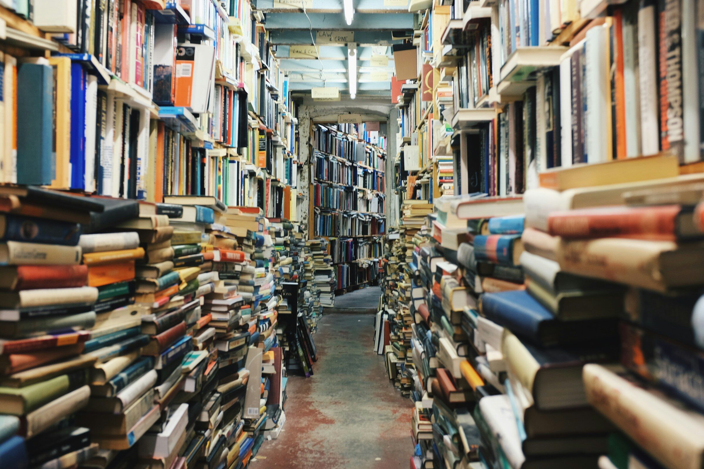 A pathway between piled books