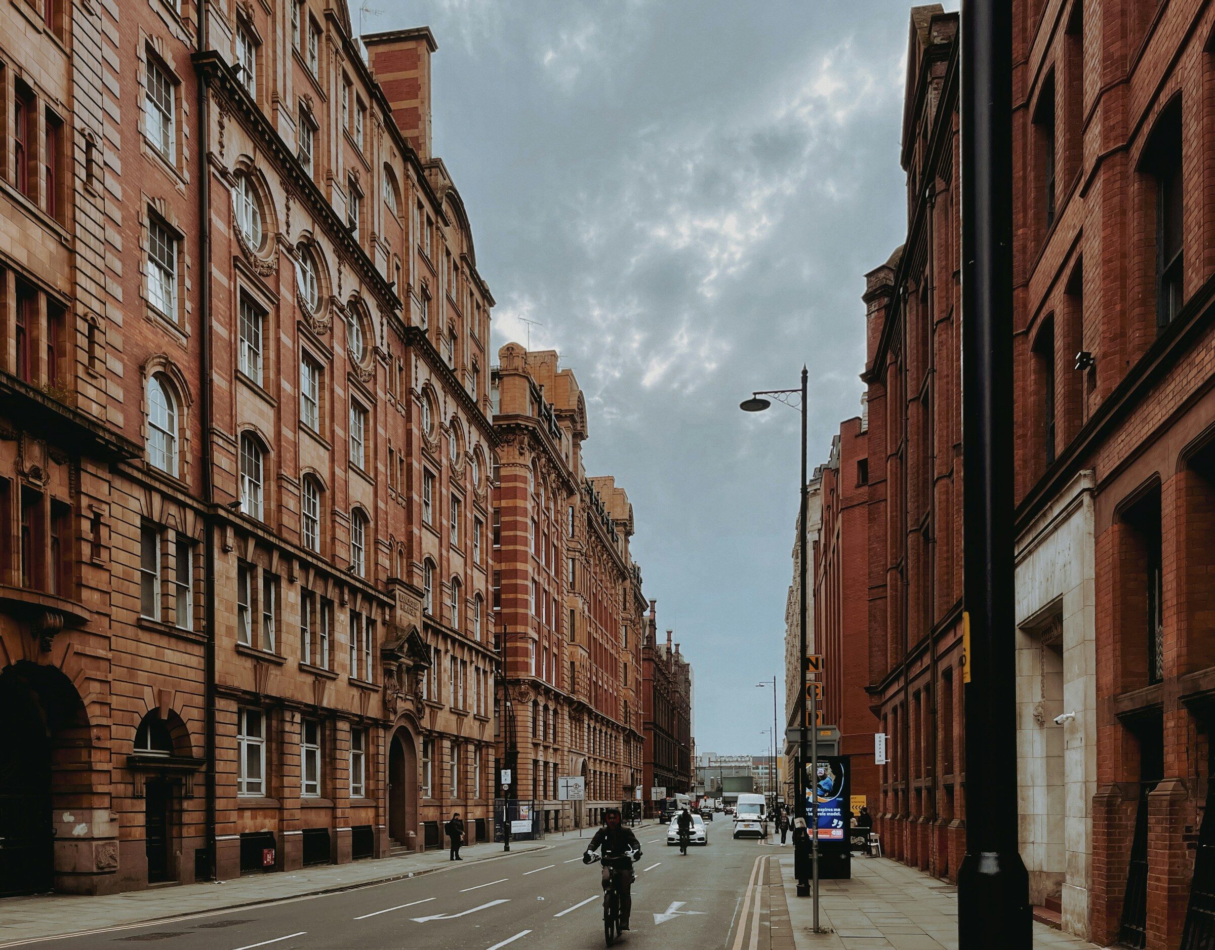 Manchester street lined with tall red-brick buildings