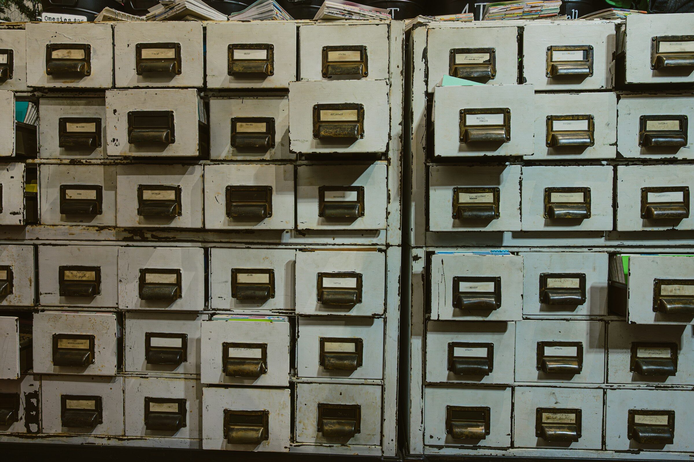 Rows of old filing cabinets with handwritten labels