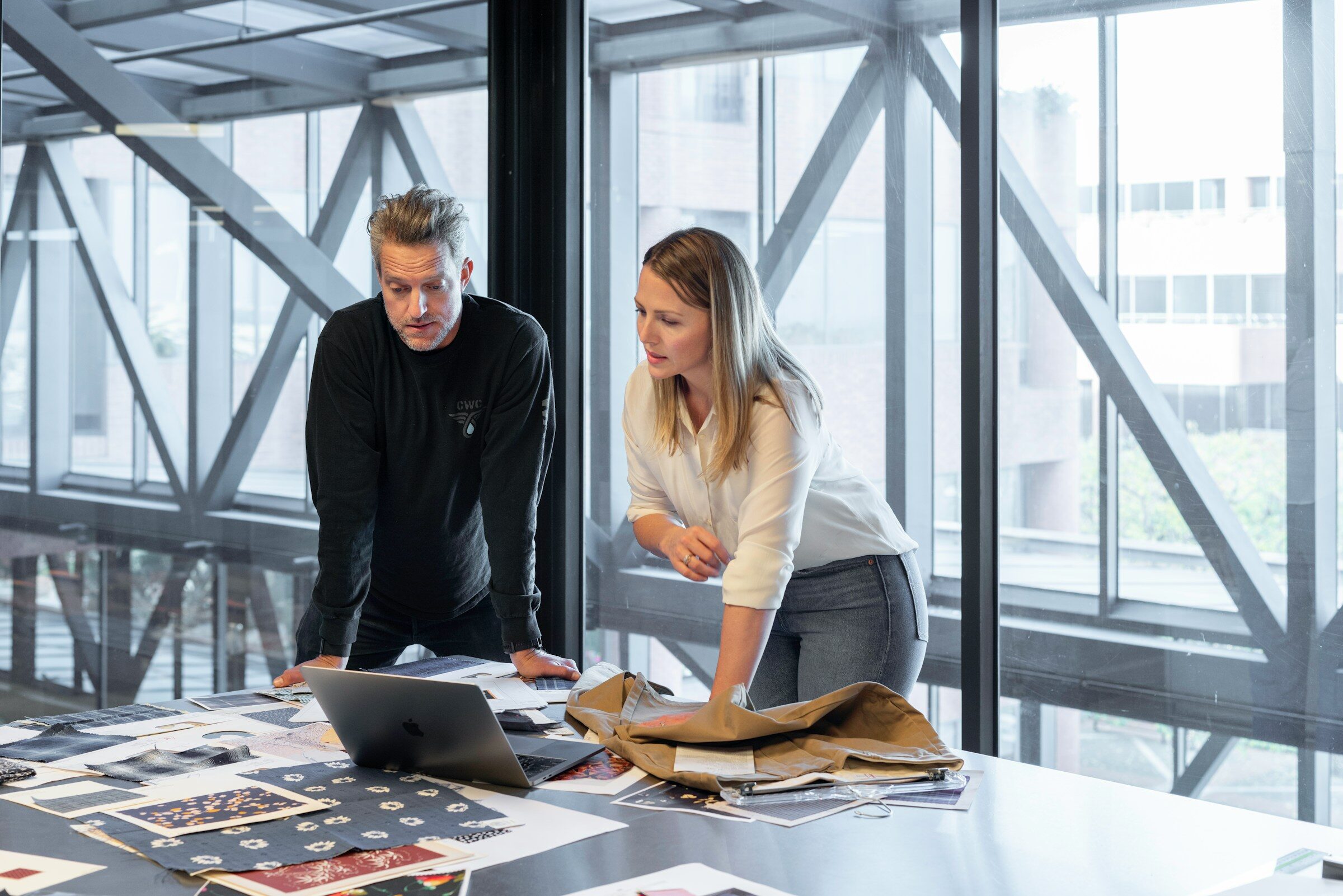 Two colleagues working through the month’s figures