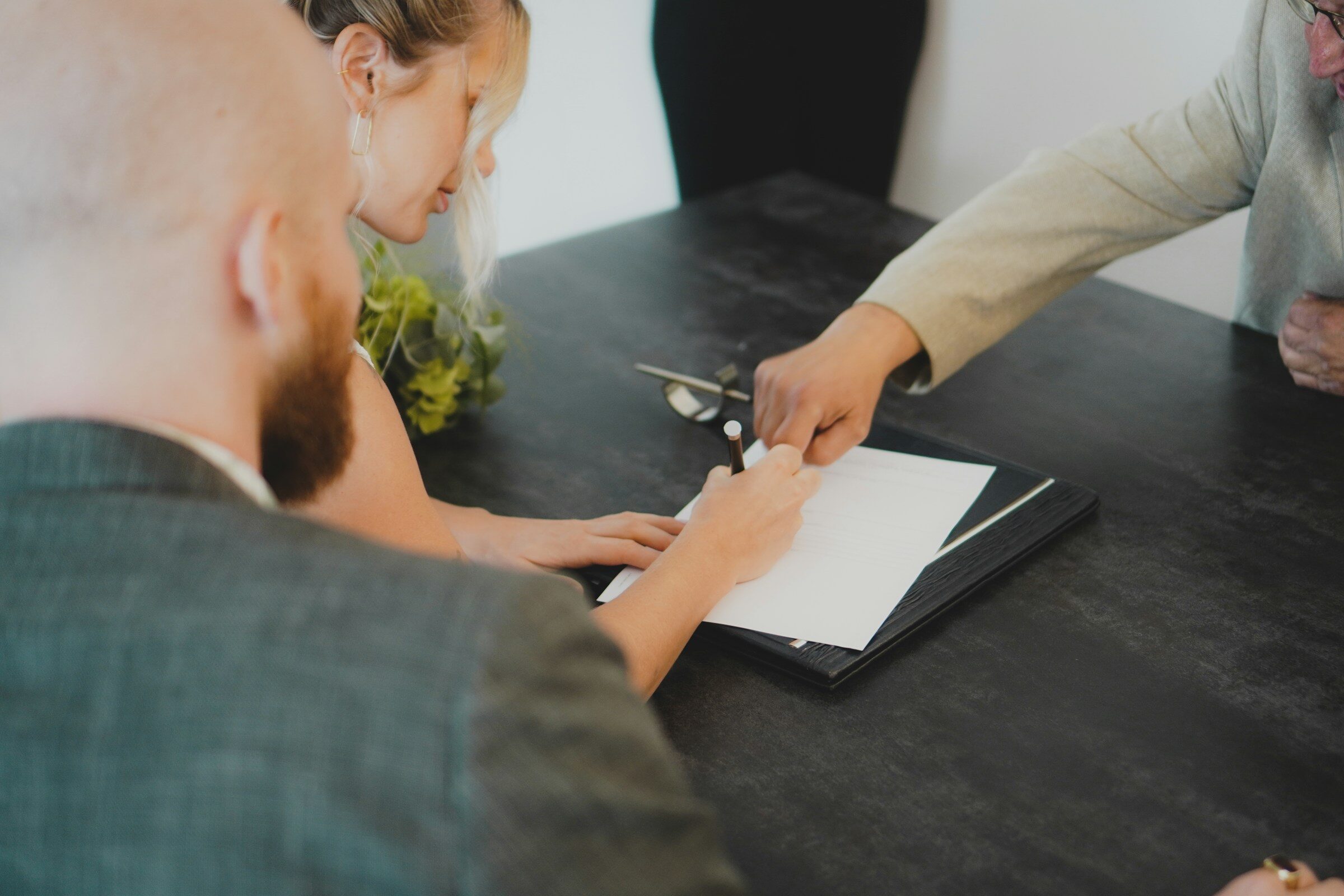 Signing a document at a desk
