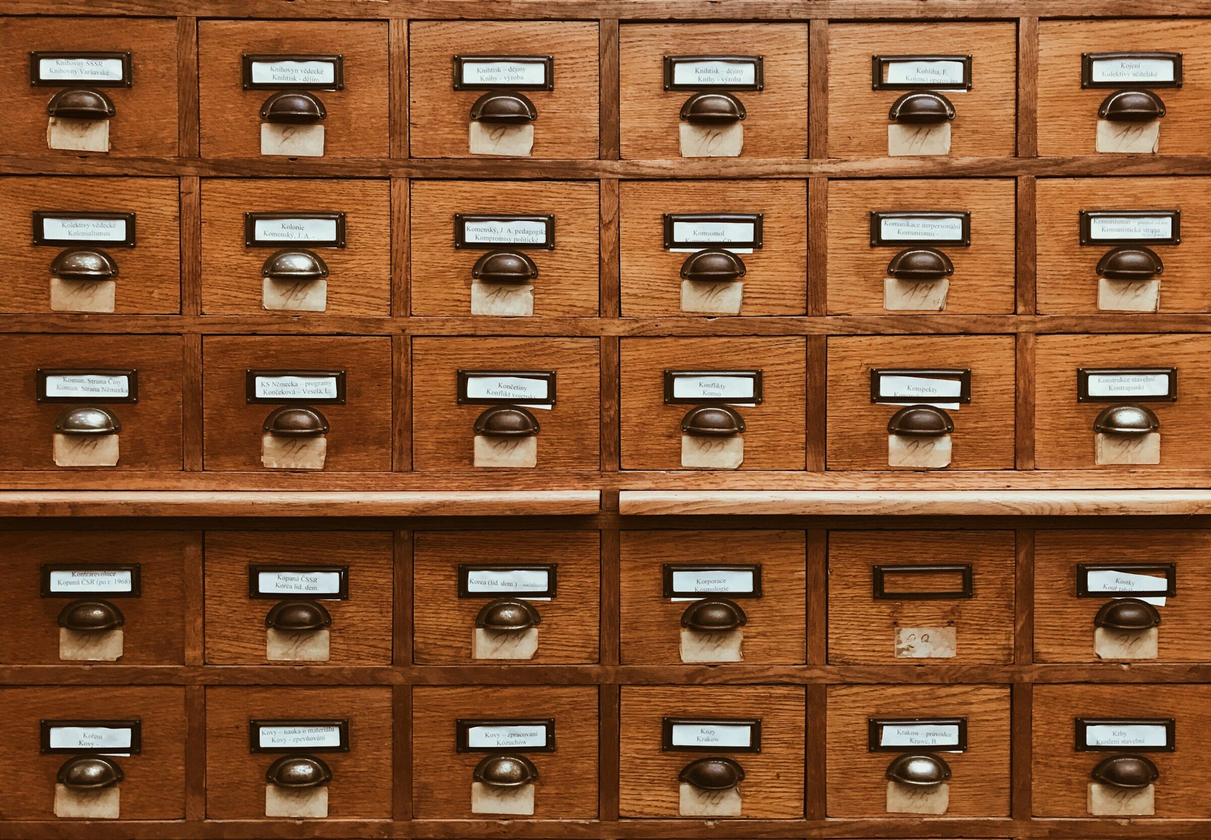 A labelled wooden drawer in a filing system